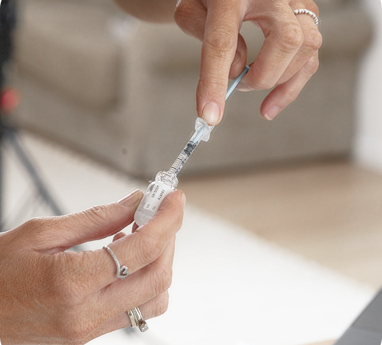 two hands pulling syringe