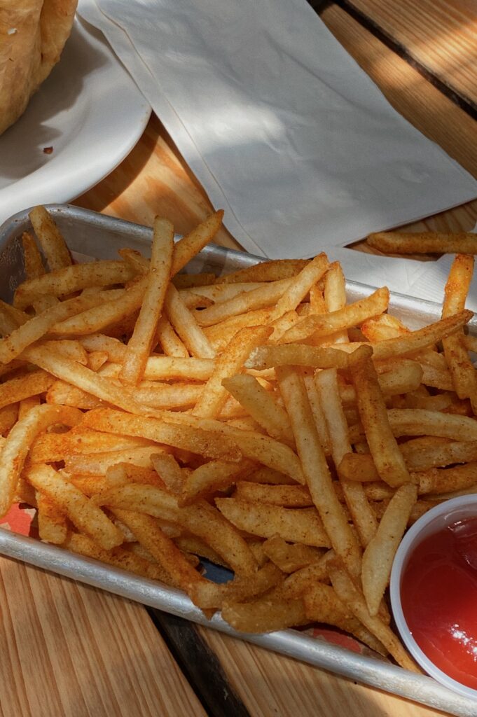 Fries on metal tray with side of ketchup